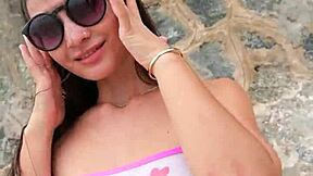 pretty brunette babe flashes bikini teasing beach crowds outdoors