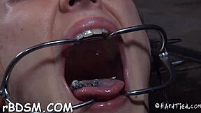 Sexy toy teases brunette slave's hidden slit delights