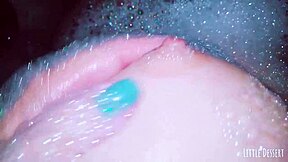 A petite teen babe with small tits gropes her wet pussy in the bath