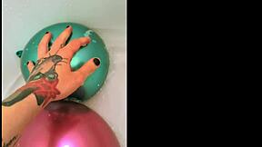 yo, check this tattooed babe teasing her trimmed pussy with bath balloons