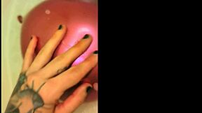 yo, check this tattooed babe teasing her trimmed pussy with bath balloons