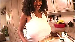 Fucking black milf's big tits and shaved pussy on bed