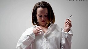 curious brunette housewife smokes teasingly in blouse and bra