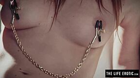 bound redhead writhes as nipple clamps and ball gag force intense orgasm