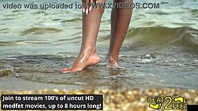 giggles rubs her feet all over giant hot rock at beach backstage