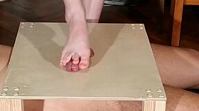 mistress stomps slave cock bare feet then footjobs him hard