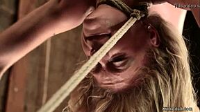 Blonde slave hogtied and hung by hips for rough choking deepthroat punishment!