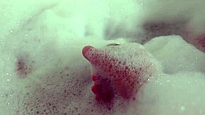 she relaxes in bubble bath fingering her wet pussy solo