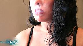 Matte red lipstick on milf lips. Brunette housewife smokes fetish style