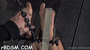 Her exposed wet cunt takes brutal flogging while bound and sucking cock wildly