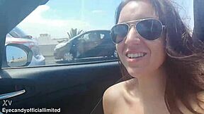 Naughty brunette flashes natural tits pussy from sports car top down