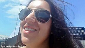 Naughty brunette flashes natural tits pussy from sports car top down