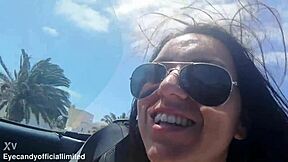 Naughty brunette flashes natural tits pussy from sports car top down