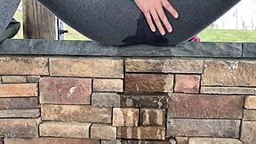 A horny teen girl soaks her tight leggings in steaming piss outdoors.