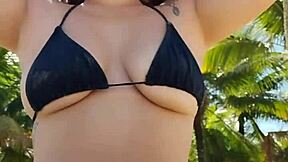 curvy african exhibitionist slips into tiny bikini and flashes hunks on beach