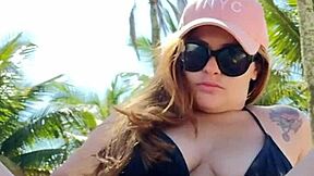 curvy african exhibitionist slips into tiny bikini and flashes hunks on beach
