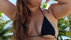 curvy african exhibitionist slips into tiny bikini and flashes hunks on beach