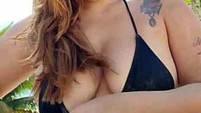 curvy african exhibitionist slips into tiny bikini and flashes hunks on beach