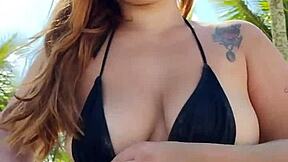 curvy african exhibitionist slips into tiny bikini and flashes hunks on beach