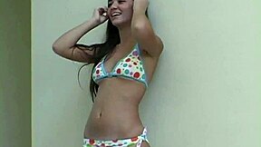 Brunette babe flashes natural tits during bikini photoshoot backstage