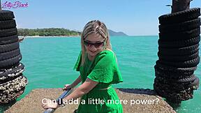 Pretty milf walks beach in dress buzzing from remote vibrator toys