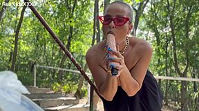 blonde cougar in glasses and miniskirt rams big vibrator deep into shaved wet cunt till red and dripping outdoors