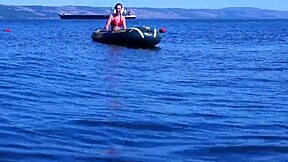 amateur mature woman poses erotically in bikini on boat floating volga river outdoors