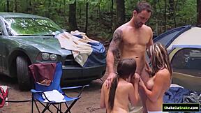 the brunette shaved twins go wild outdoors, sucking and jerking in a steamy public threesome handjob frenzy.