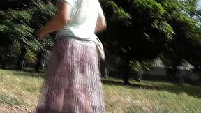 Hairy mature flashes plump pussy through see-through dress outdoors
